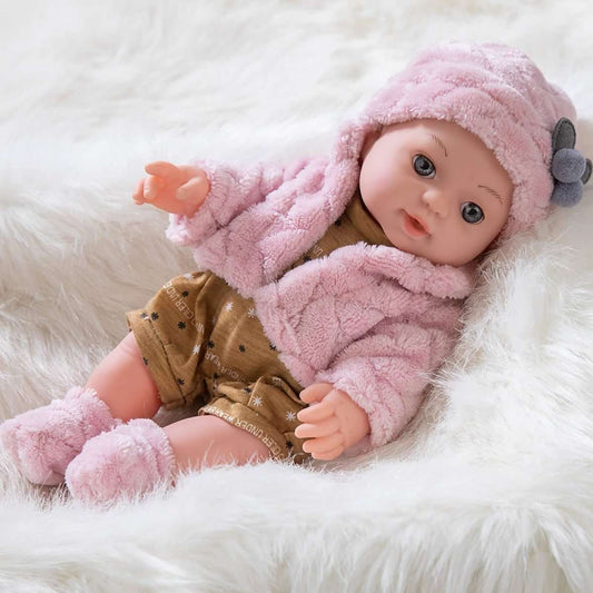 Pink plush baby doll lying down, wearing hooded jacket and tan star overalls