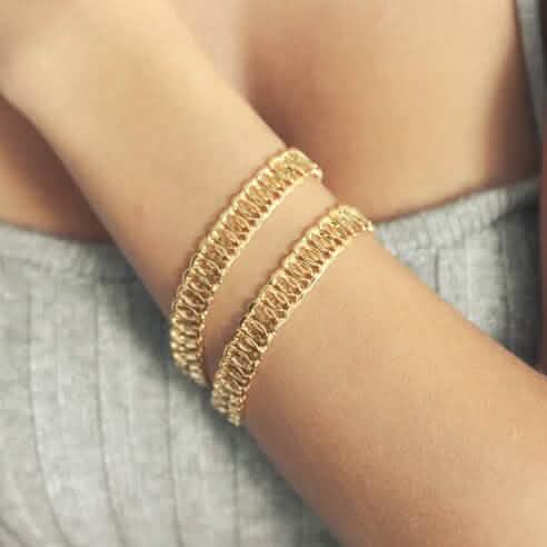 18K gold chunky chain bracelet on wrist, showing textured link pattern