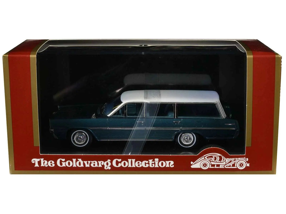Die-cast station wagon model in display box, dark teal body with white roof and blue interior