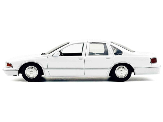 1:24 white unmarked police Caprice diecast car, side view