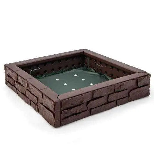Kids brown plastic sandbox with green bottom liner and brick-style sides