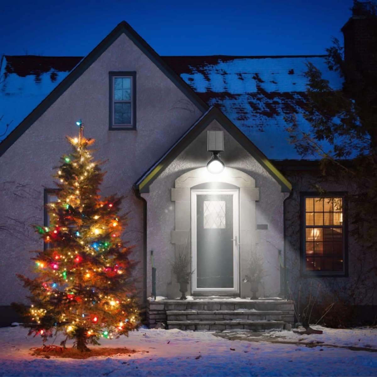 Outdoor solar spotlight with glowing round LED head and mounted solar panel on entry steps