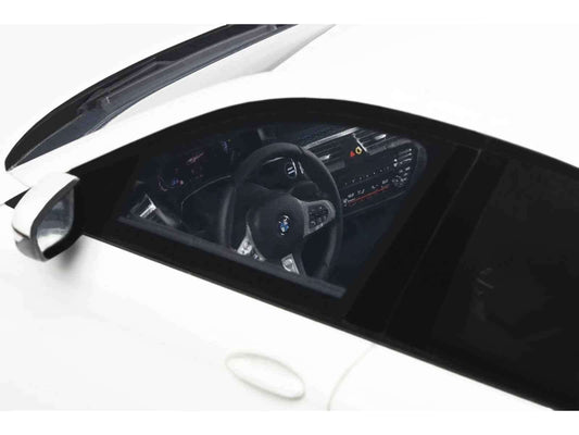 White die-cast sports car model front view with black kidney grille