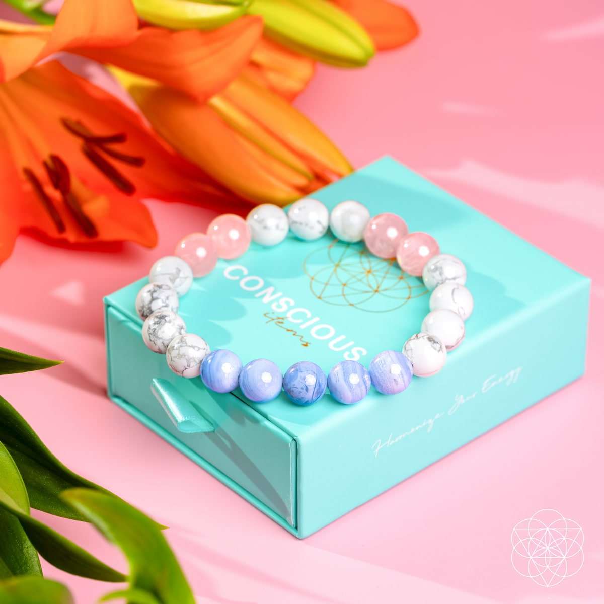Beaded bracelet on blue gift box with pink, white, and light blue stone beads