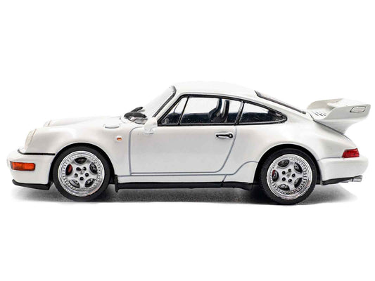 White Porsche 911 diecast model car, side profile with black wheels and stripe detail.