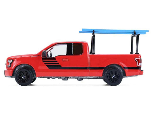 Red diecast pickup truck with black stripes and blue ladder rack, side profile