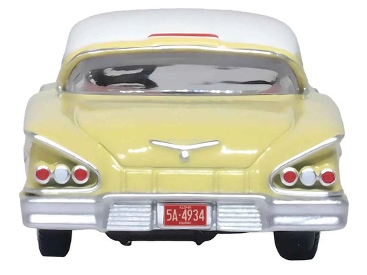 Cream 1958 Chevrolet Impala HO scale diecast with white roof, rear view.
