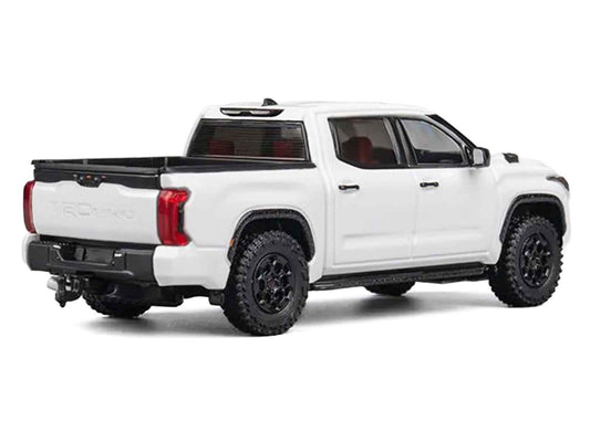 White Toyota Tundra diecast pickup model car, rear three-quarter view, black wheels