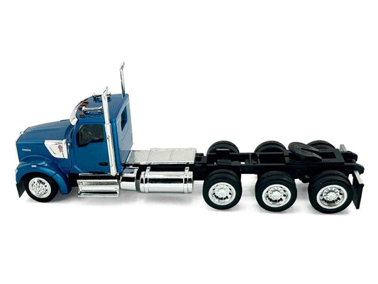 Blue HO semi truck model, side view with chrome fuel tanks and triple-axle wheels