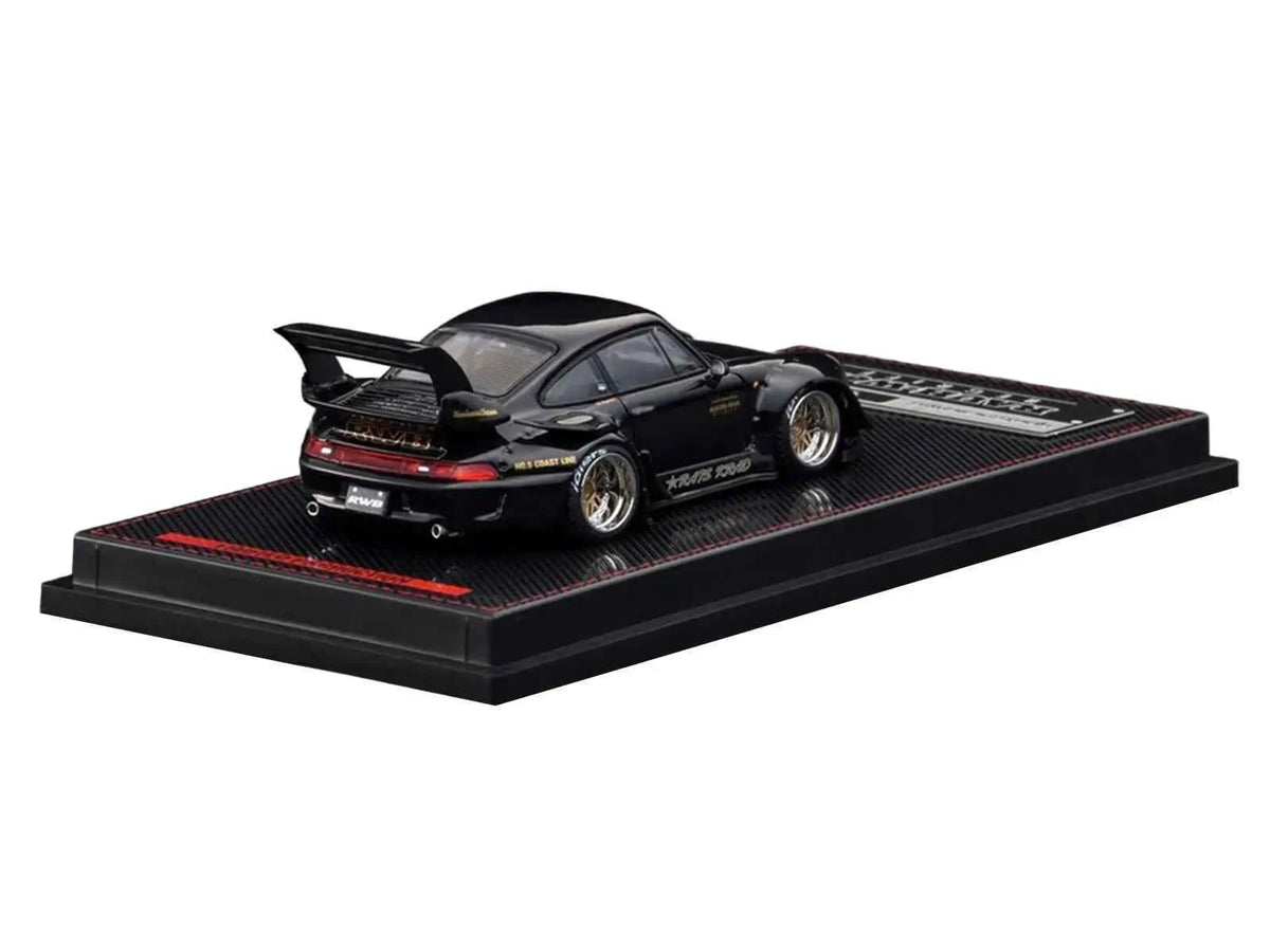 1/64 diecast model car in black, rear three-quarter view on textured display base