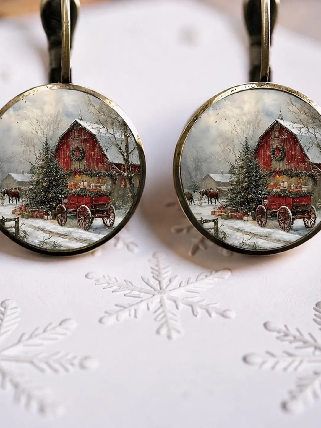 Round farm-scene holiday earrings with red barn and snowy landscape, gold-tone hooks