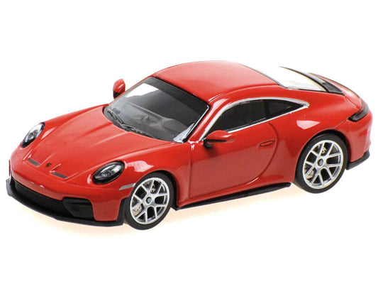 Red diecast sports car model with black hood and silver wheels