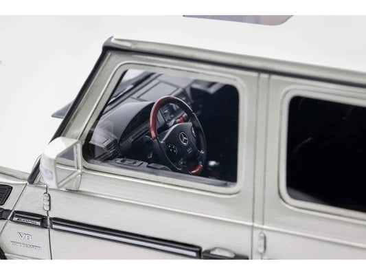Die-cast SUV model car interior view through windshield with steering wheel