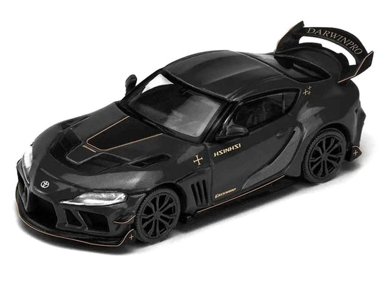 Black diecast sports car with gold stripe and rear spoiler, front 3/4 view