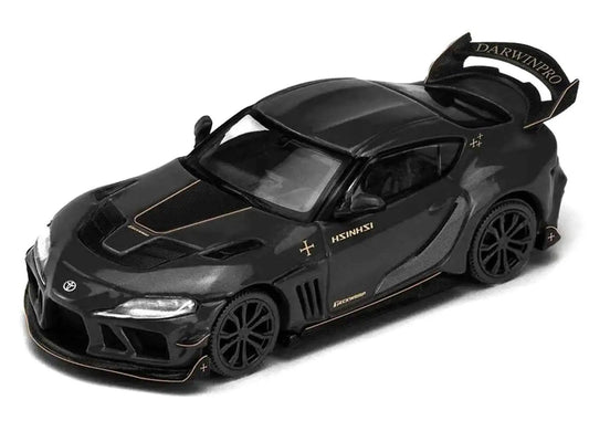 Black diecast sports car with gold stripe and rear spoiler, front 3/4 view