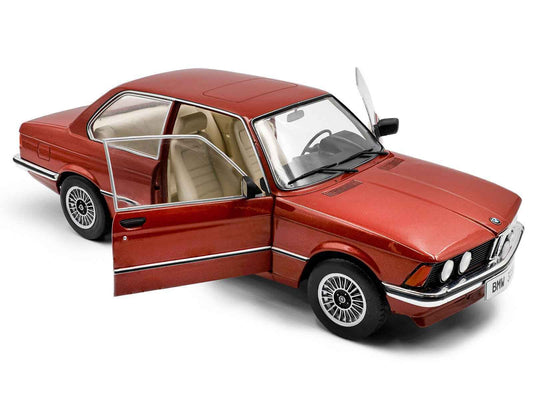 Solido diecast model car: red 1980 BMW 323i with open driver door, front 3/4 view.