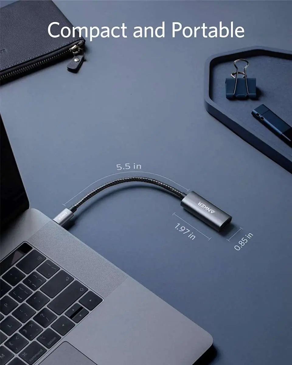 Compact USB-C to DisplayPort adapter with braided cable for portable desk setup.