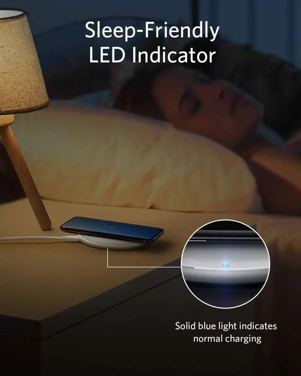 Wireless charging pad with blue LED indicator while a phone rests on top