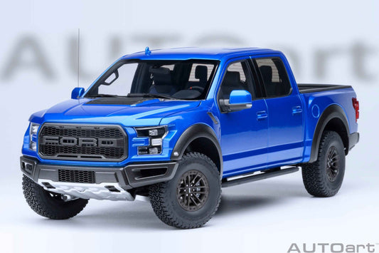 Blue pickup truck model with detailed front grille, headlights, and black wheels, angled view