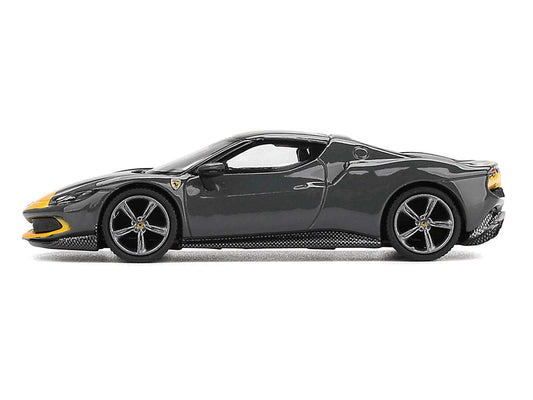 Dark gray diecast sports car model with yellow stripes, side profile