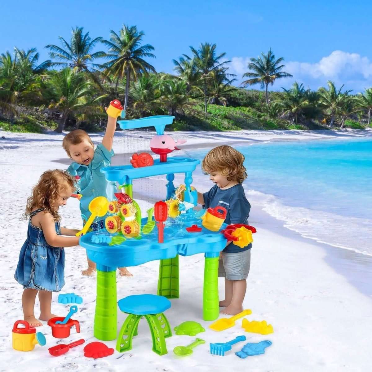Kids sand and water table with blue top, red fish sprinkler, green legs, and play accessories