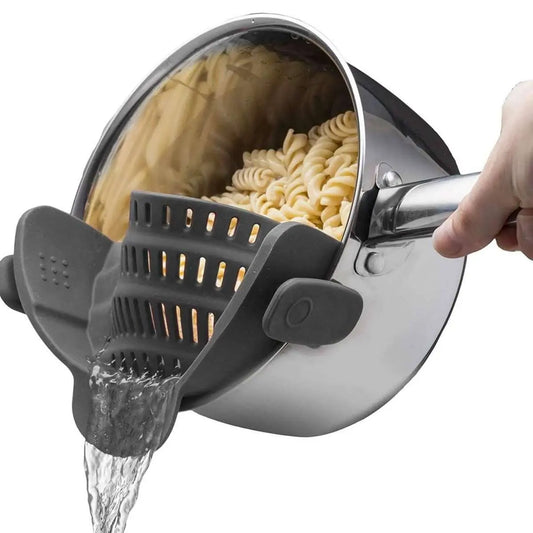 Gray snap-on strainer with perforated basket and draining noodles