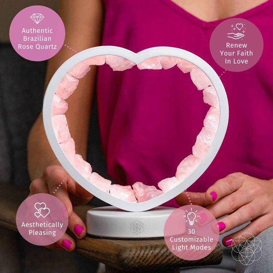 Heart-shaped rose quartz lamp with pink stone ring on a gray base