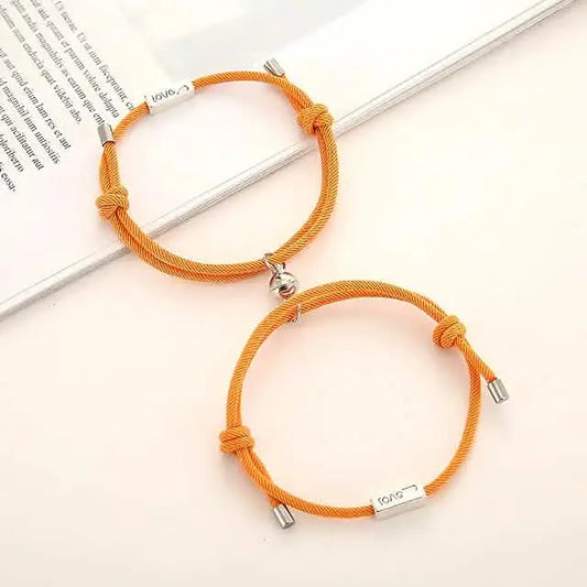 Magnetic rope couple bracelets in orange, with knot details and silver magnetic clasp ends