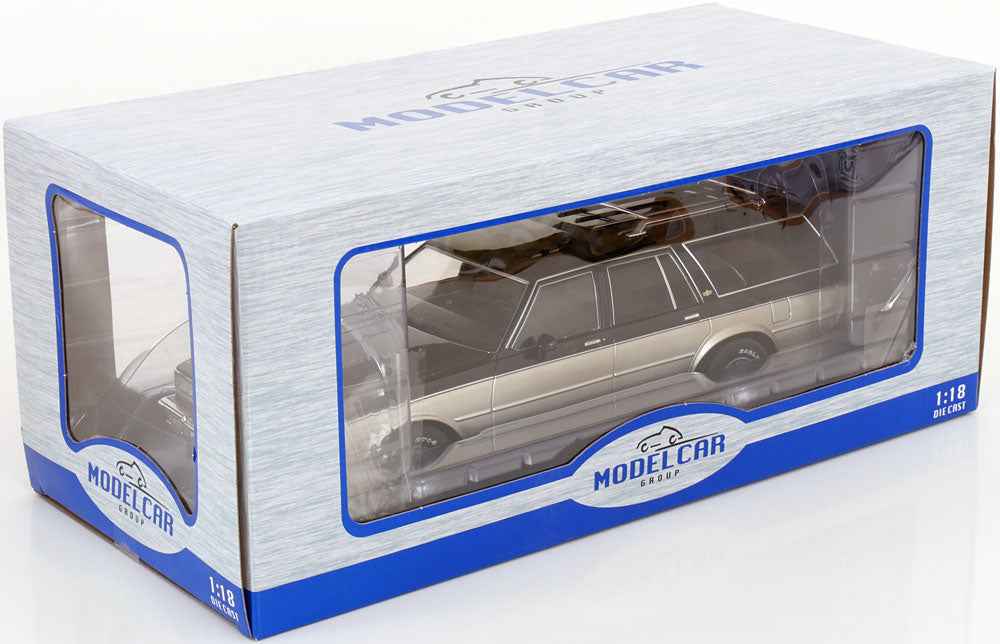 Grey and silver station wagon die-cast model in box with clear window, 1:18