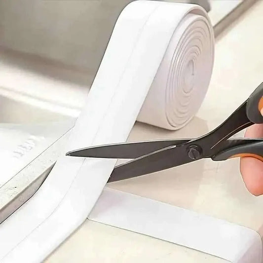 White sink gap sticker tape roll and scissors trimming for corner fitting