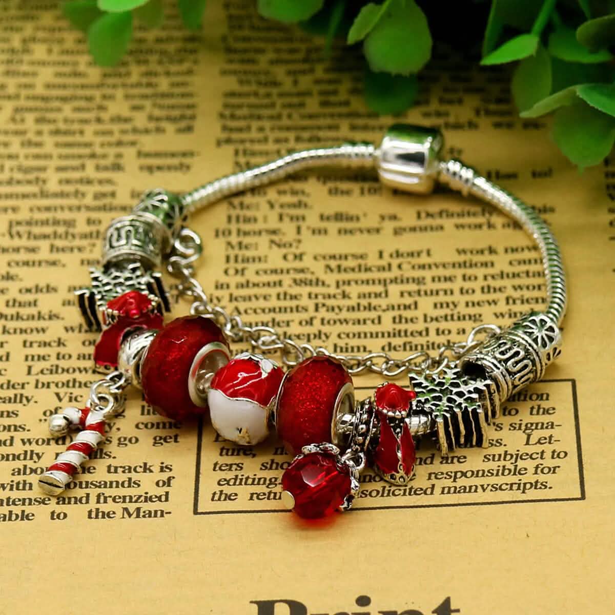 Red crystal Christmas charm bracelet close-up with Santa, stocking and bell charms