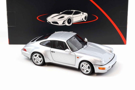 Silver Porsche 911 die-cast model car, side front three-quarter view with four-spoke wheels