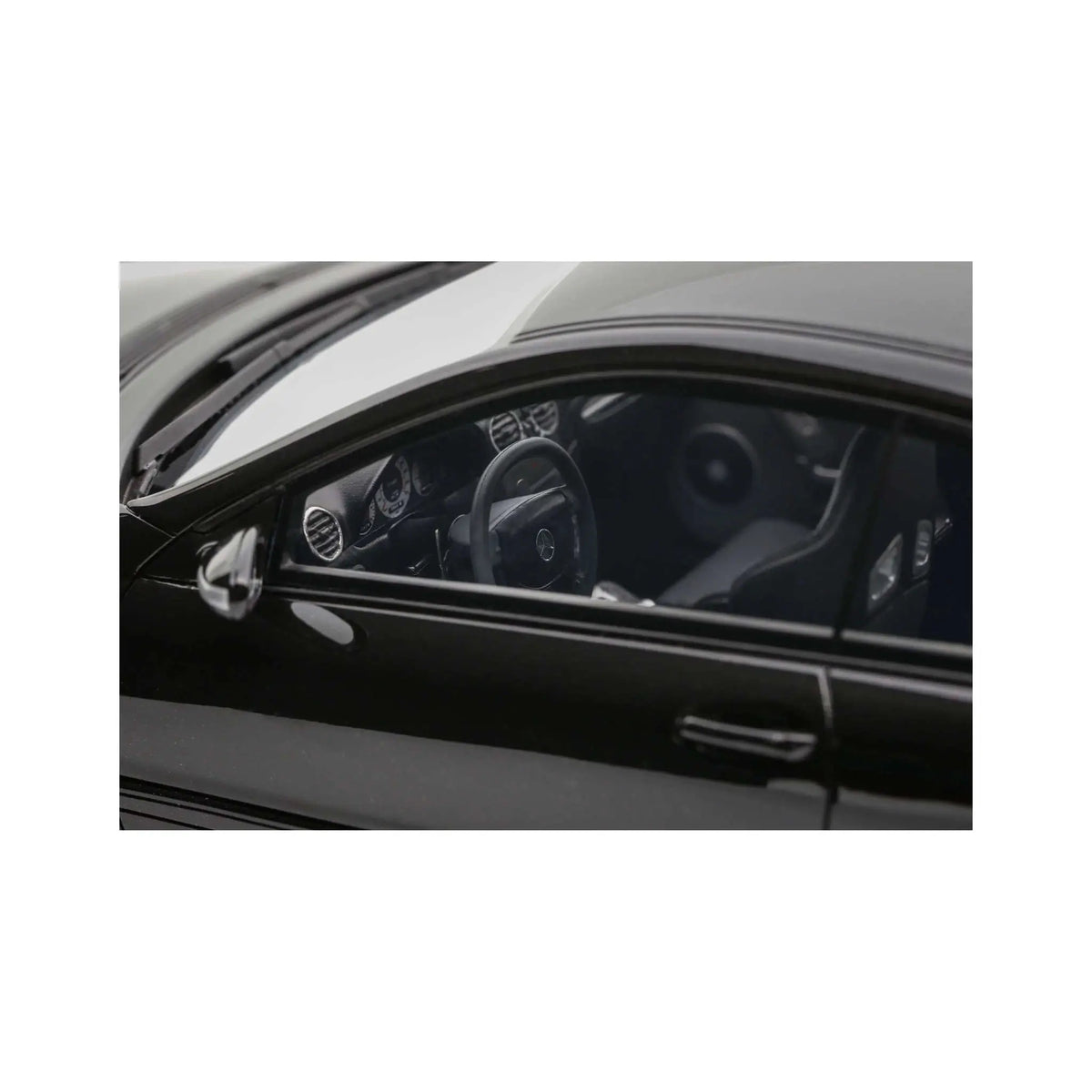 Obsidian black die-cast coupe model, close-up of cockpit interior through side window.