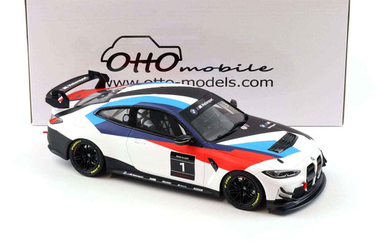 Die-cast race car model with white body, blue stripe, red accents, side 3/4 view.