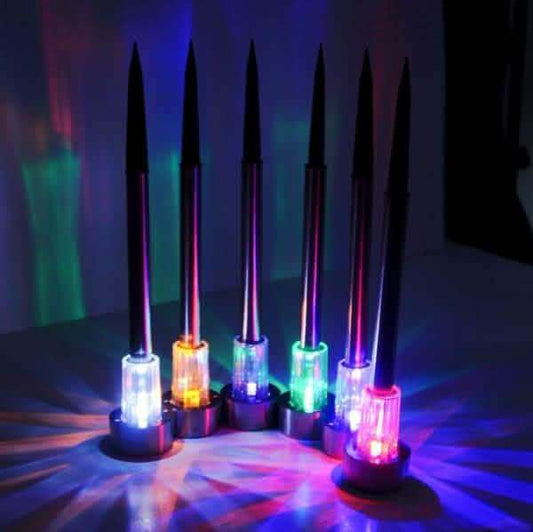 Outdoor solar LED garden lights, glowing multicolor bulbs on spike stakes