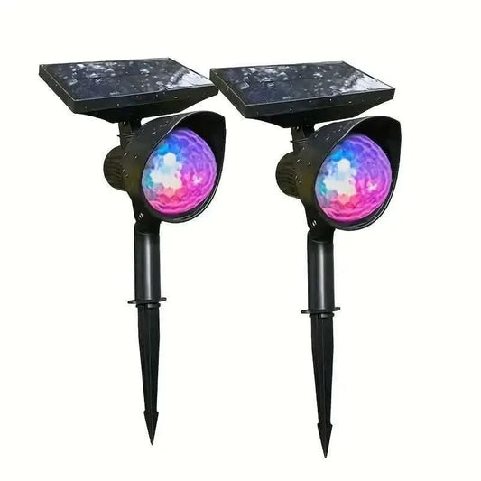 Two black solar projection lamps with open lens showing rotating colored light
