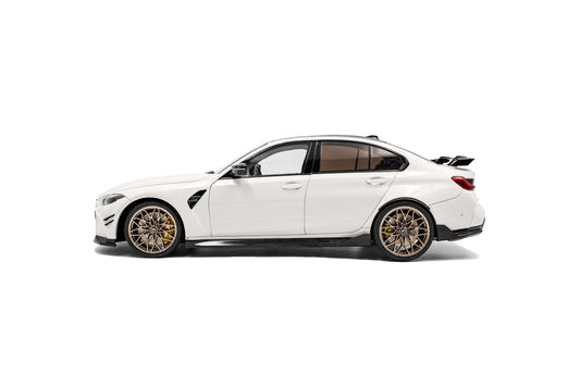 White BMW M3 die-cast model car side view with gold spoke wheels and rear spoiler