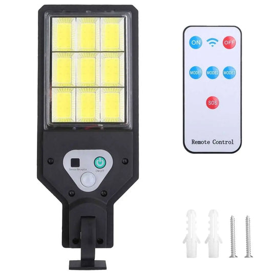 Solar outdoor wall light close-up, black LED grid, remote control and mounting screws