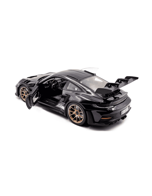 Purple die-cast sports car model with gold wheels and open hood, side interior view