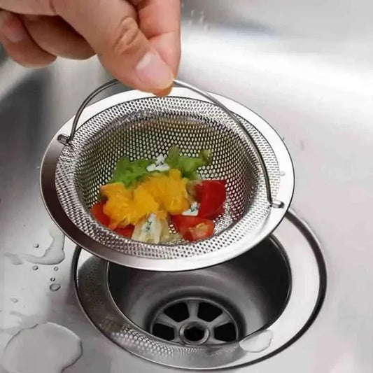 Stainless steel mesh drain catcher holding colorful hair and debris over drain