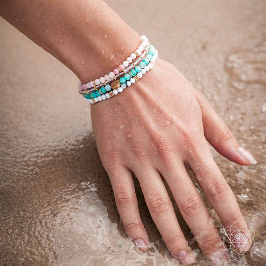 Turquoise and white beaded bracelet set on wrist with small gold spacer beads