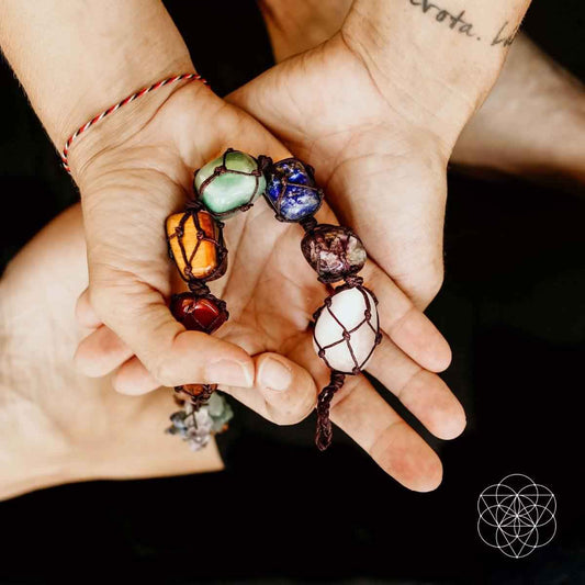 Bead chakra tassel bracelet on hands, multicolor stones with small hanging charm