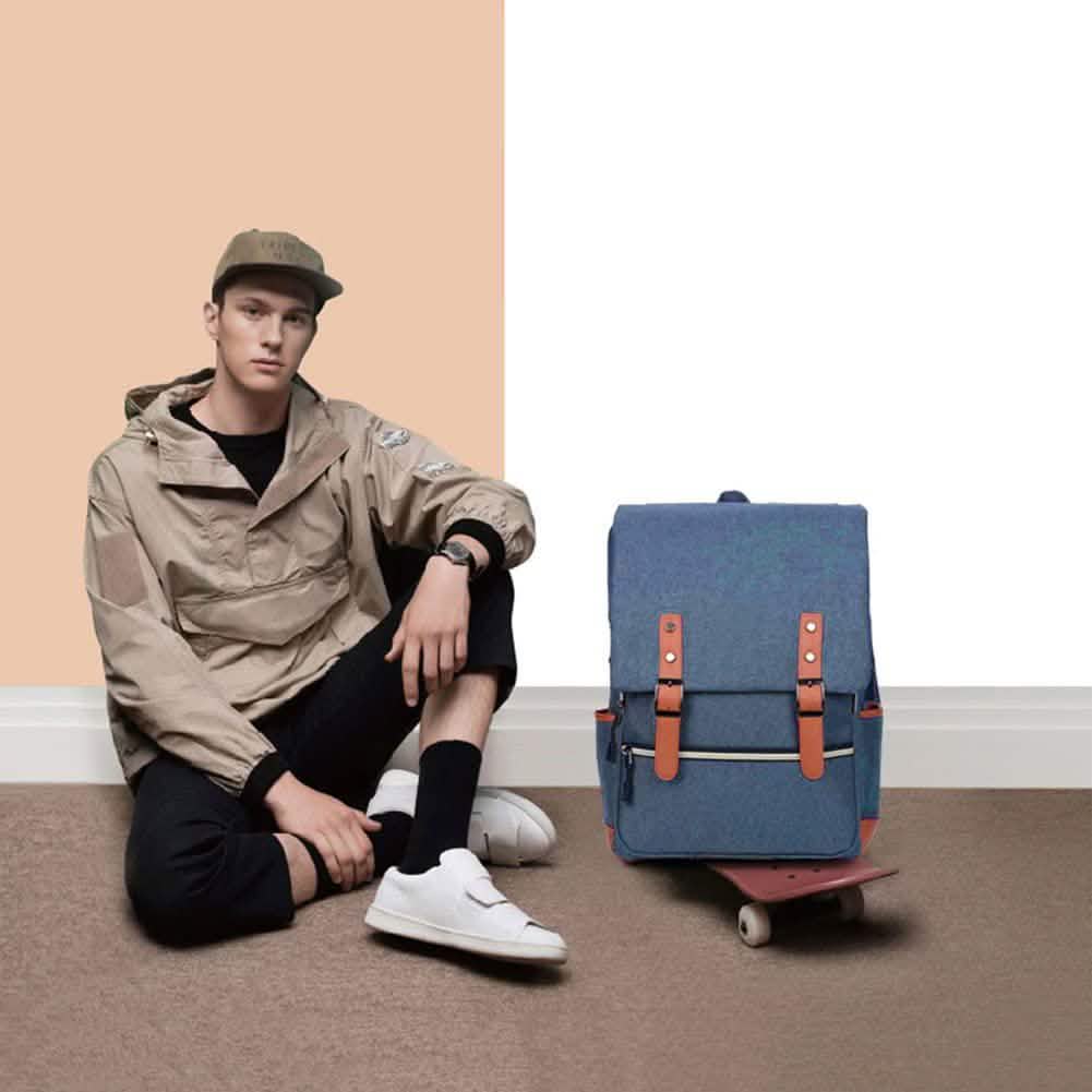 Blue laptop backpack with front flap and brown leather straps, with side zippers