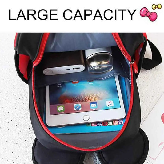 Kids mini backpack open with red-trim zipper, holding a tablet and small items inside