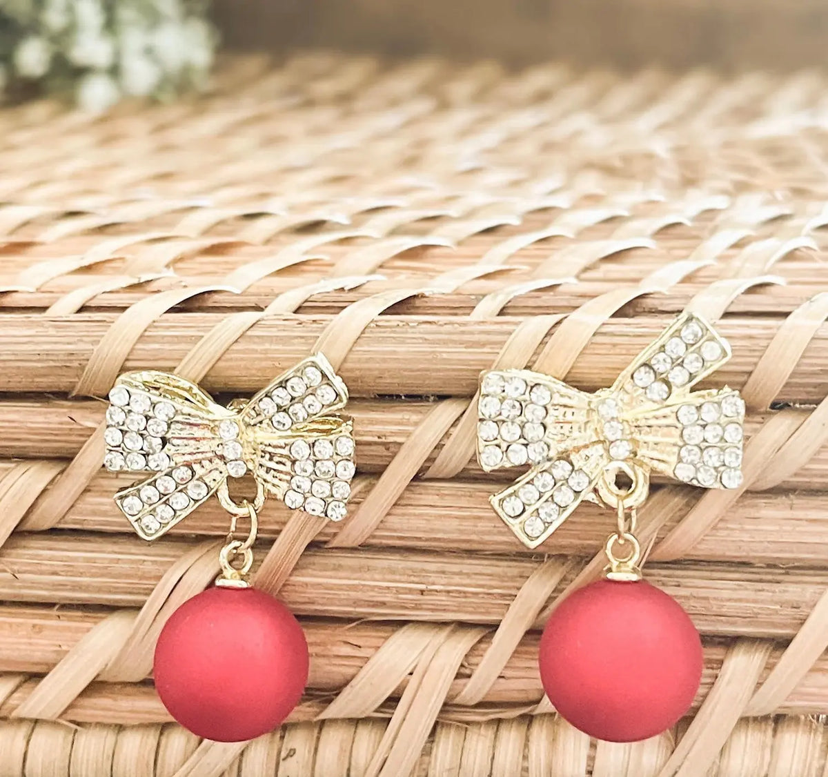 Rhinestone gold-tone bow ornament with two red ball drops and dangling hooks