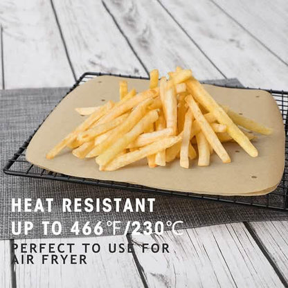 Beige air fryer parchment liner holding French fries in fryer basket