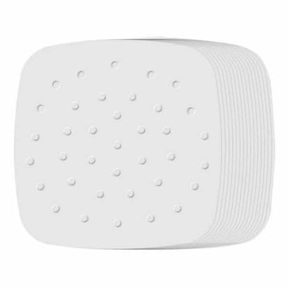 White square air-fryer parchment papers, perforated holes, stacked