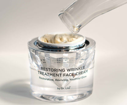 Restoring Wrinkle Treatment face cream jar with applicator dispensing white cream