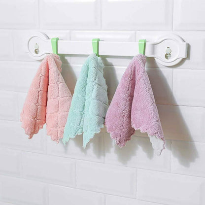 Set of pastel kitchen dish towels hanging on a rack: pink, mint, and lavender.