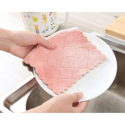 Kitchen dish towel, pink, resting on a white plate